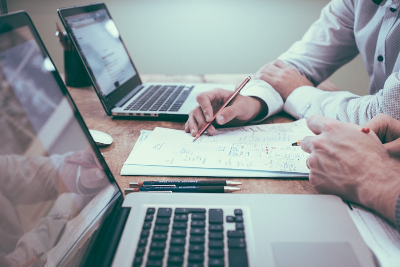 Business professional reviewing financial data on a laptop at a desk